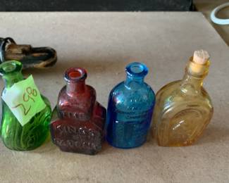 #298	vintage 3" Wheaton color bottles (4)	 $30.00 			
