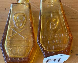 #171	Yellow glass poison medicine bottle skull & cross bone, set of 2, 3"tall	 $50.00 			
