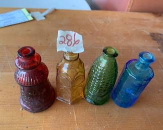 #286	vintage 3" Wheaton color bottles (4)	 $30.00 			
