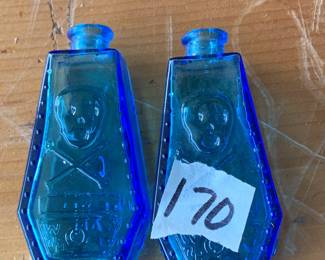 #170	Blue glass poison medicine bottles skull & cross bone set of 2, 3"tall	 $50.00 			
