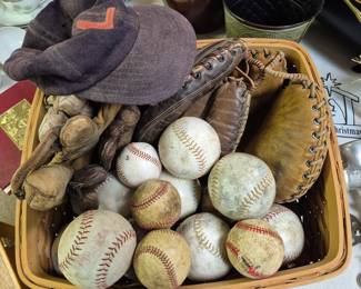 Vintage baseball gloves, balls and bats