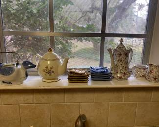 Many pretty tea pots and tea sets 