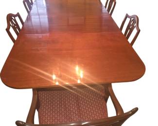 A Classical style carved mahogany 3 pedestal dining table with 2 additional leaves. Second half  19th Century.