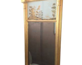 Re-gilded Federal carved and giltwood eglomise mirror. First quarter 19th Century.  