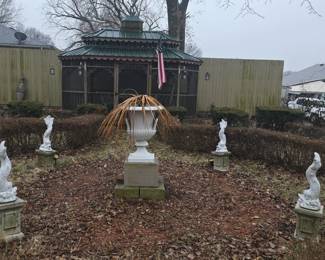 Set of four painted and cast cement dolphin fountain ornaments on partial painted metal plinths 