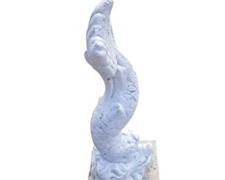 Close up of one of four painted and cast cement dolphin fountain ornaments