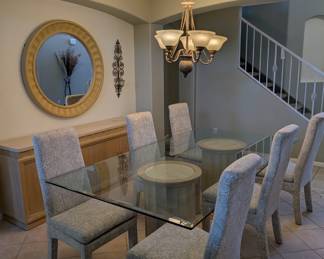 Large glass table top dinning room set with matching buffett, end tables, coffee table and entry table and mirror