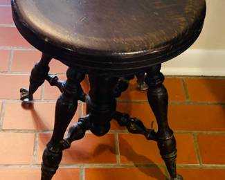 early piano stool with claw feet and glass inserts