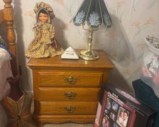 Night stand by Athens Furniture group, homemade vintage dish bottle doll, brass touch lamp and talking clock