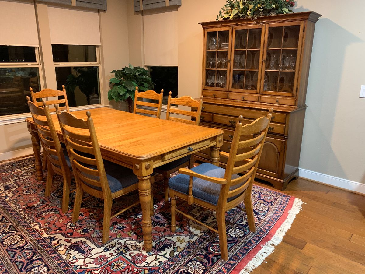 Solid wood dining room table with chairs and two expansion pieces. 