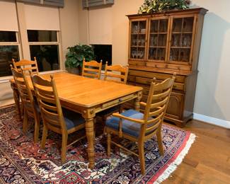 Solid wood dining room table with chairs and two expansion pieces.