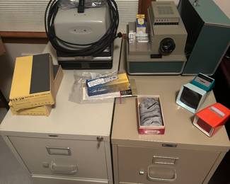 Metal file cabinets seem to be all the rage right now! They are selling like hot cakes! On the top are some beautiful vintage 35 MM slide/projector items! 
