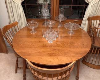 The dining room table is a lovely set! Table, with two leaves, two captains chairs, 4 chairs. Also has the felt covers. On top of the table is some exquisite crystal. 