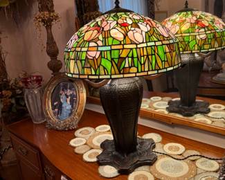 Signed QUOIZEL Table Lamp with Leaded and Stained-Glass Floral Shade Lamp on Ornate Peacock Feather Bronze Base
