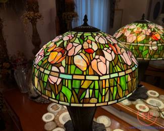 Signed QUOIZEL Table Lamp with Leaded and Stained-Glass Floral Shade Lamp on Ornate Peacock Feather Bronze Base