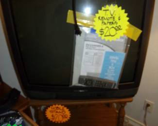 Television with Controller and Paperwork - Wood Stand