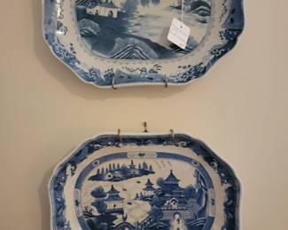 Two decorative blue platters in the style of Canton ware.