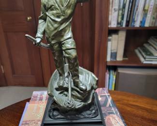 In the style of Winslow Homer, a patinated metal lamp base. 