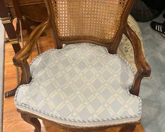 $330. Caned chair with arms and cushion. Available for online purchase per the instructions on the sale details page, pickup is during in-person shopping hours.