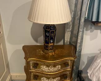 $190. Pair of gold two drawer bedside tables painted in the Florentine style one has an as found issue on a knob. Each measures 24 inches wide by 13 inches deep by 25.5 inches. Available for online purchase per the instructions on the sale details page, pickup is during in-person shopping hours.