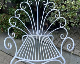 One of a pair of metal chairs.