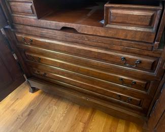 interior view of the drawers on the bottom of the armoire.