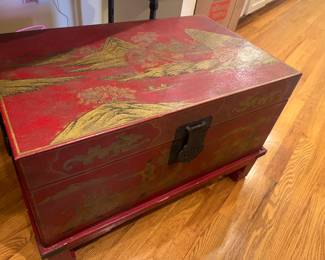 $420. Red and gold Asian trunk on a base. 27.25 inches wide by 17.25 inches deep by 16.7 inches high.  Interior view next.  Available for online purchase per the instructions on the sale details page, pickup is during in-person shopping hours.