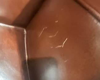 view of the as found issue inside the arm just about the seat cushion on one of the wing back chairs.