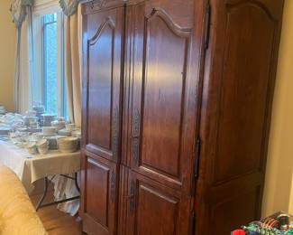$2200. Guy Chaddock country English armoire with a carved bonnet..  It measures 52 inches wide by 25 inches deep by 88 inches high.  Available for online purchase per the instructions on the sale details page, pickup is during in-person shopping hours.