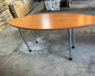 Oval wood with metal legs work table.  65"w x 22"d x 29.5"h.  Available for in-person shopping on Friday and Saturday only