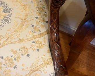 A close-up view of the beautifully carved arms.