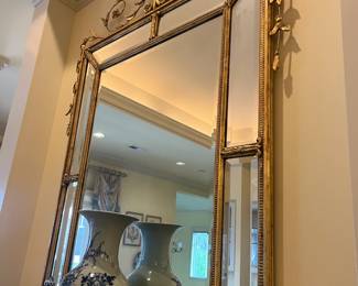 $880. Gilded mirror with urn and floral crown detailing. Approximately 48 inches wide by 65 inches high. Available for online purchase per the instructions on the sale details page, pickup is during in-person shopping hours.