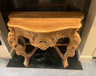 $380 Unfinished carved wood demi-lune table.  38.5 inches wide by 18.5 inches deep by 31 inches high. Available for online purchase per the instructions on the sale details page, pickup is during in-person shopping hours.