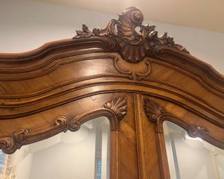A close-up of the crown on the armoire.