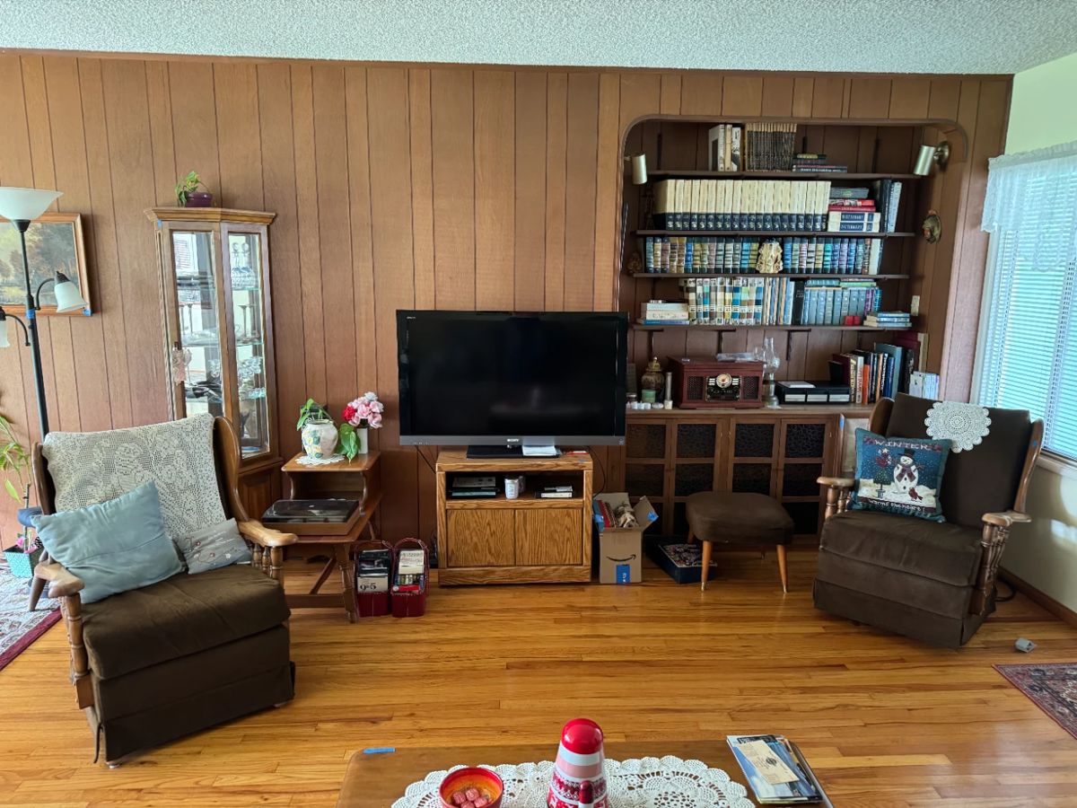 1960s rocking/swivel chairs; curio cabinet; ottoman; TV; TV stand; books; vinyl records