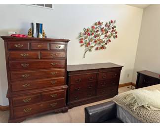 cherry chest of drawers and dresser wall art
