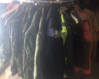 A full rack of hunting apparel and Carhartt coats.