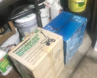 New in the box spreader and 2 charcoal grills!