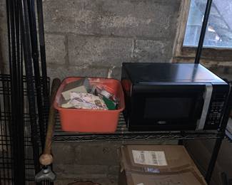 Shelving unit   Basket of Christmas ribbon   Microwave