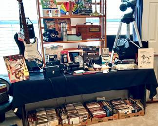 Guitars, telescope, cds, DVDs, and Disney VHS tapes. 