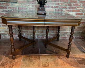 Dining table with decorative legs and custom cut matching glass top