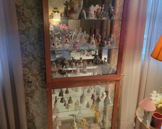 Curio cabinet and glass bell collection.