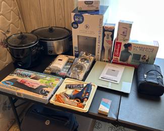 This table is filled with small home electronics! All are in excellent condition! Man come complete in their original boxes! 