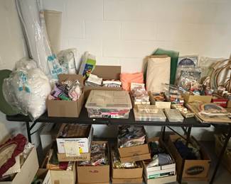 This is one of several banquet tables filled with sewing, knitting and quilting supplies! 