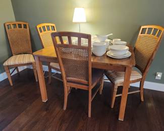 Vintage diningroom set. Table and four cane-backed chairs. Could use a recover on the seats. But overall clean and solid.