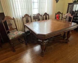 Antique dining room table with 5 chairs, 1 captains chair and 1 leaf......