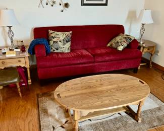 Area Rugs; Drop Wood Oak Coffee Table; Wood Oak End Tables with Drawers; Pair of Brushed Chrome Table Lamps; Decorative Pillows; Vintage Vinyl Covered Stool; Burgundy / Dark Red Sofa--Made in the USA by Best Chair Inc, Indiana; Framed Print; Floral Metal Wall Hanging