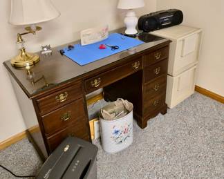 Vintage Wood Desk with Glass Top; 2 Drawer File Cabinet; Paper Shredder; Vintage Garbage Can; Brass Table Lamp; White Ceramic Lamp; Miniature Clock; Office Supplies