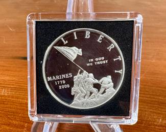 This lot features a U.S. Marine Corps 230th anniversary commemorative silver proof dollar coin, circa 2005. Kept in a protective case.