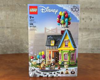 An adult-owned (built-once) Lego Disney “UP” House set. Confirmed as a complete set, guaranteed by Salem Auction House with all the original packaging. Adventure awaits Disney fans aged 9 and up with this fun LEGO® | Disney and Pixar ’Up’ House (43217). The set that everyone will be talking about includes a detailed section of the iconic house with a chimney and balloons, 2 LEGO minifigures, a LEGO dog figure, a wilderness explorer backpack and an adventure book. Kids can also enjoy an easy and intuitive building adventure with the LEGO Builder app, which lets them zoom in and rotate models in 3D, save sets and track their progress.